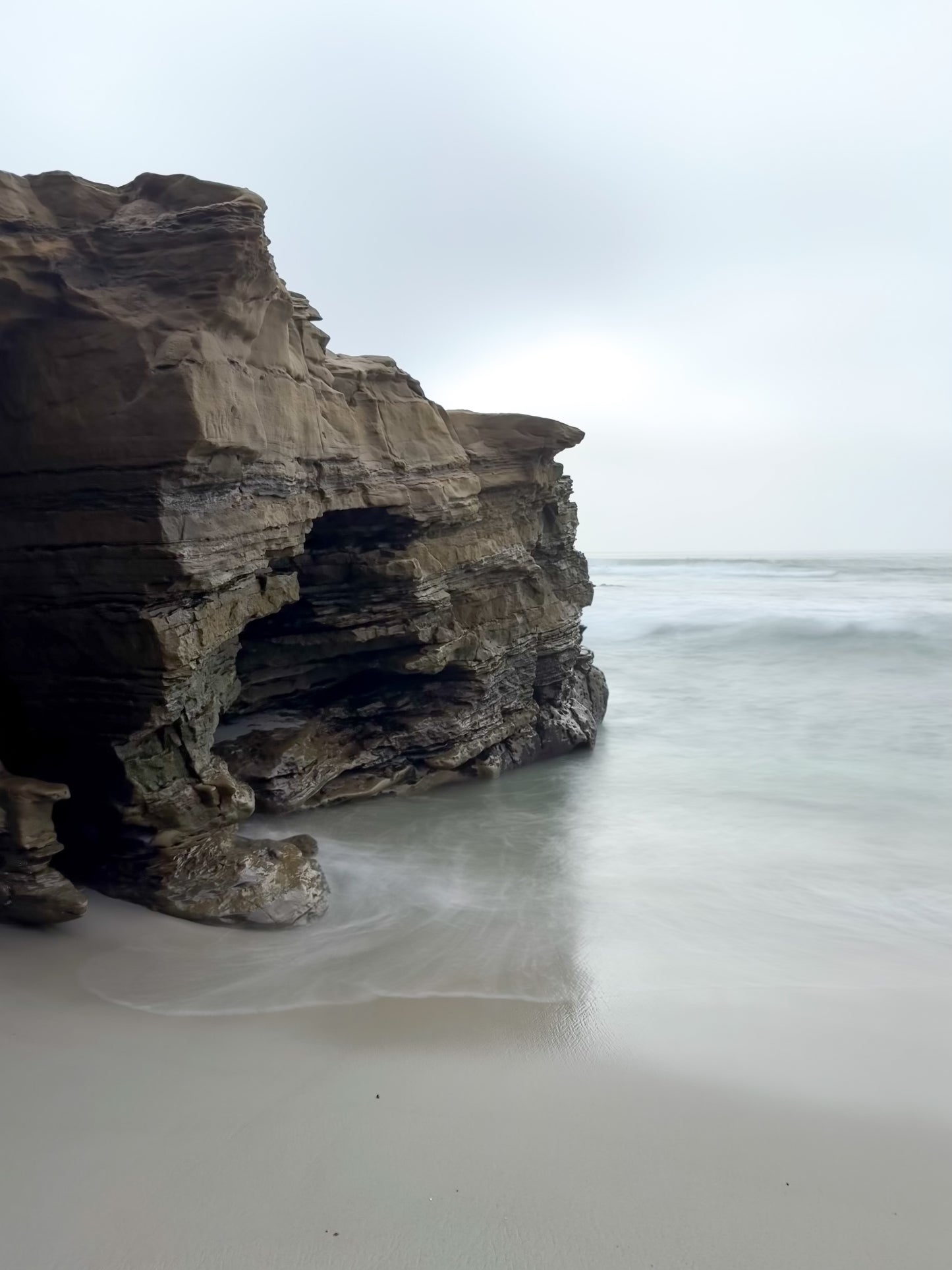 Rugged Coastal Cliffs at Windansea - Fine Art Print by Leslie Brashear Photography captures the dramatic rocky shore and tranquil waves of Windansea Beach, perfect for San Diego photography enthusiasts.