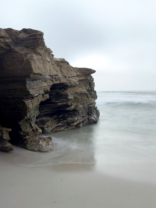 Rugged Coastal Cliffs at Windansea - Fine Art Print by Leslie Brashear Photography captures the dramatic rocky shore and tranquil waves of Windansea Beach, perfect for San Diego photography enthusiasts.