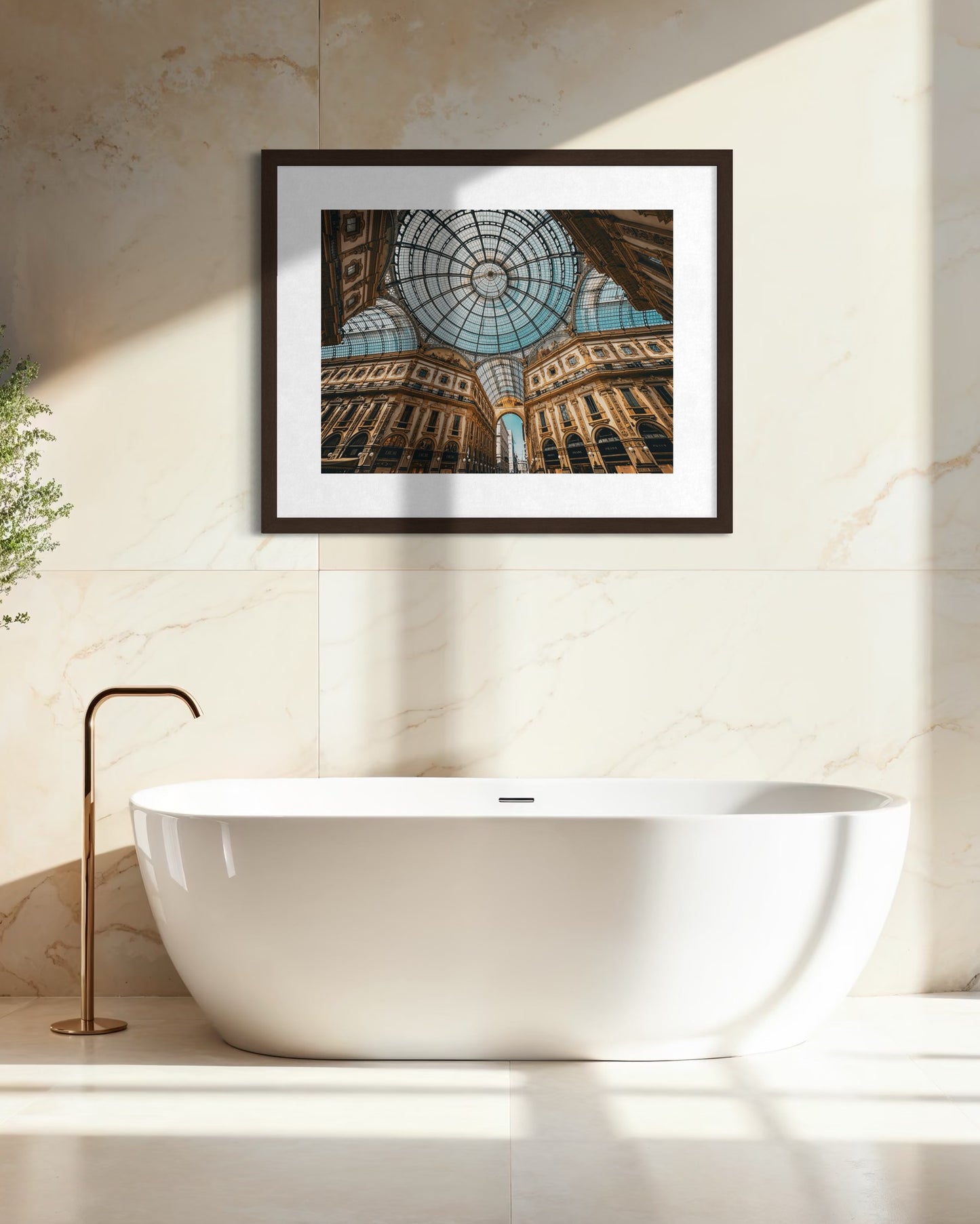 A modern bathroom with a white freestanding tub, brass faucet, and the "Galleria Vittorio Emanuele II - Fine Art Print" by Leslie Brashear Photography displayed on a beige marble wall.
