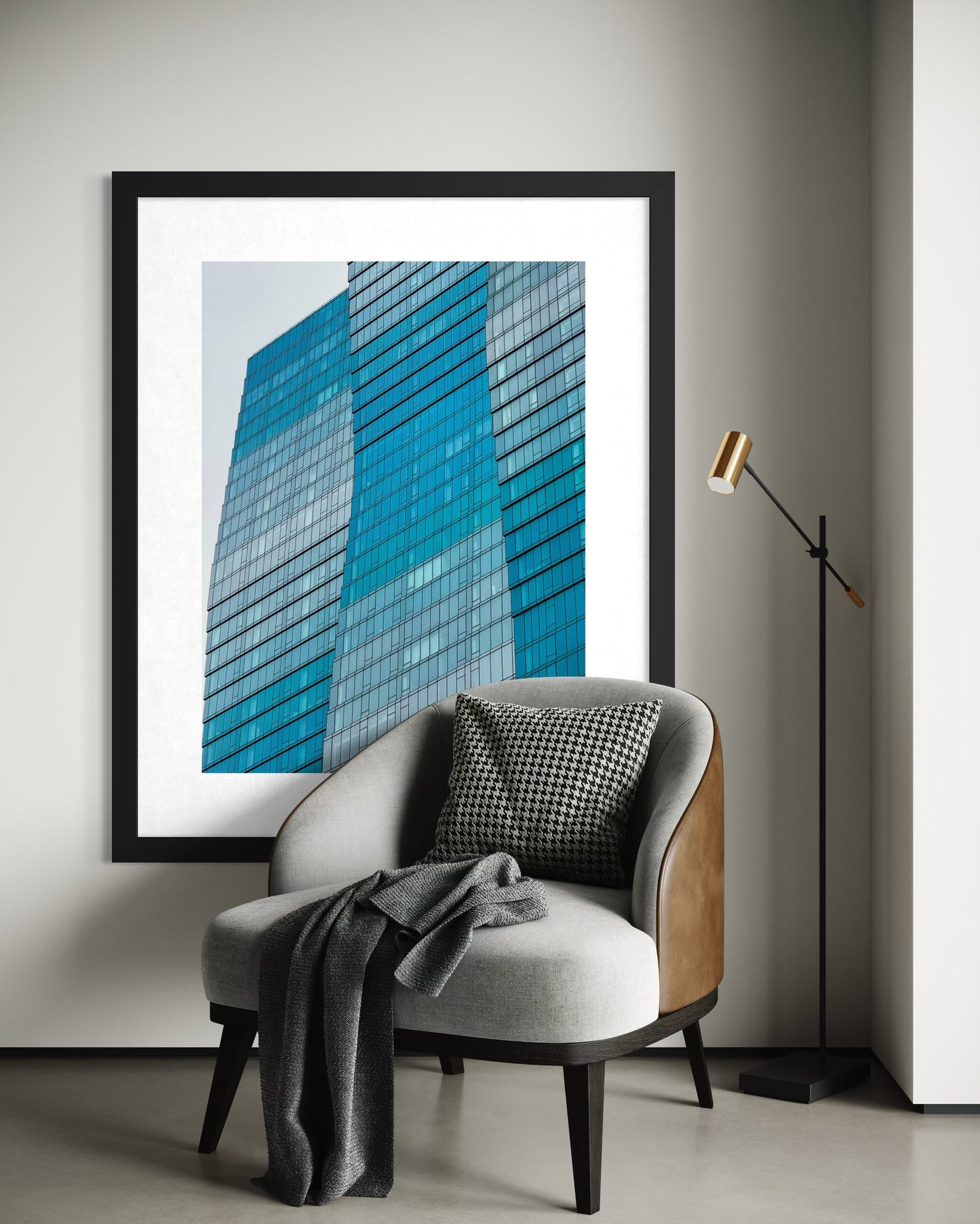 The "Wavy Building - Fine Art Print" by Leslie Brashear Photography hangs behind a contemporary armchair with a blanket and cushion, accompanied by a floor lamp.