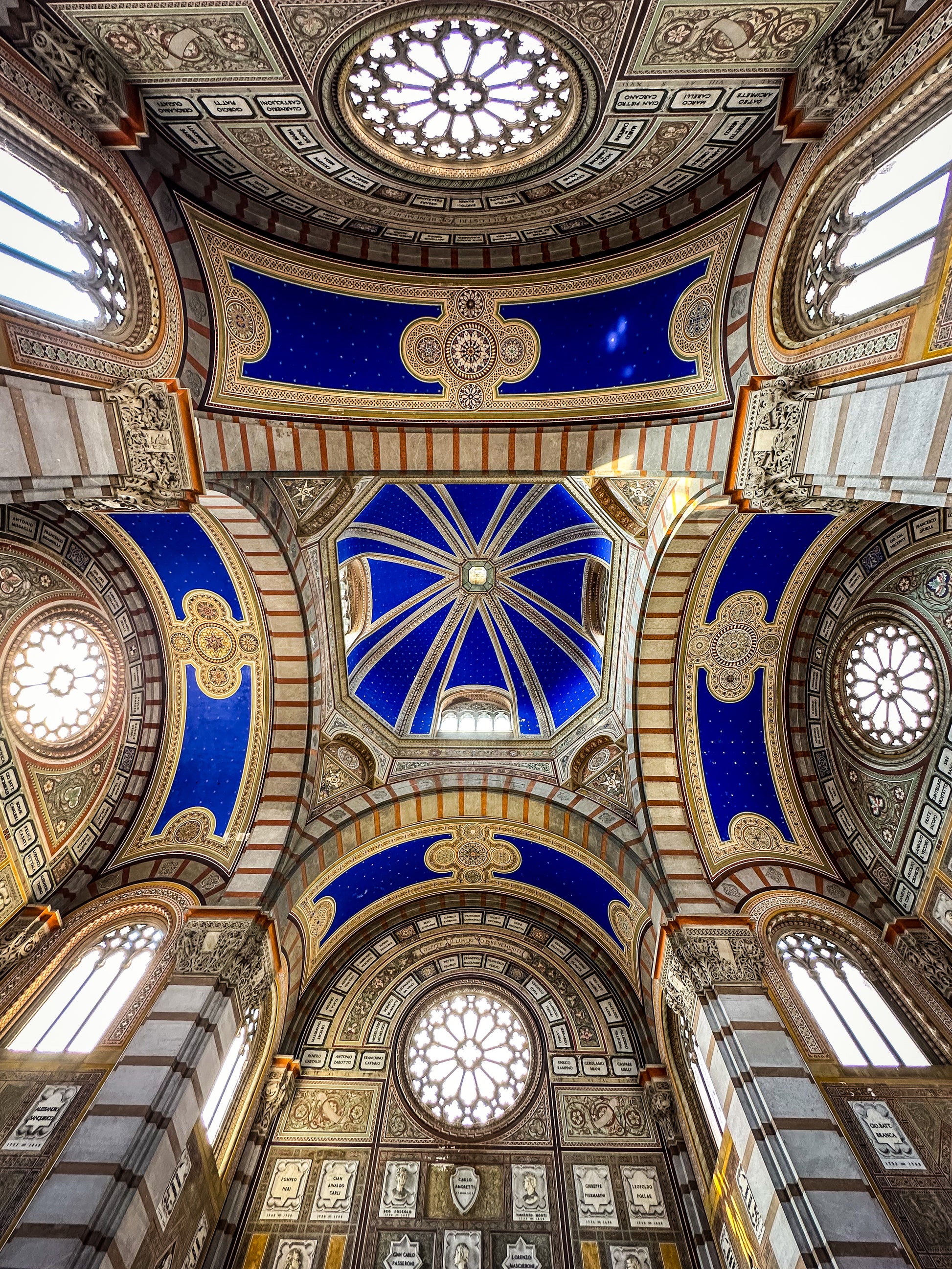 Stunning Ceiling - Fine Art Print by Leslie Brashear Photography captures an ornate cathedral’s arched ceiling with blue and gold details, stained glass windows, and decorative patterns, viewed from below in exquisite architectural detail.