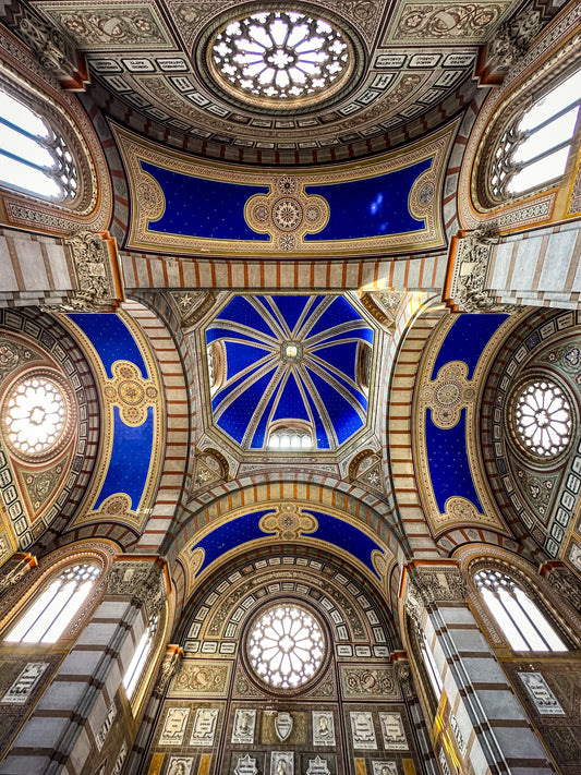 Stunning Ceiling - Fine Art Print by Leslie Brashear Photography captures an ornate cathedral’s arched ceiling with blue and gold details, stained glass windows, and decorative patterns, viewed from below in exquisite architectural detail.